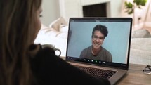 a young woman working from home on a video conference 