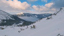 Panorama of winter alps mountains with ski center resort in snowy nature

