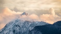 Evening clouds over alpine peak in winter Time lapse
