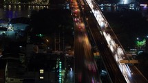 Timelapse of night traffic across the bridge