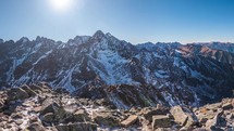 Panorama of snowy rocky alps mountains in beautiful sunny day cold winter outdoor adventure background
