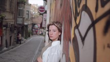 Young woman in the streets of Istanbul with Graffiti on walls