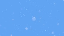 It is snowing, Snow isolated on blue sky background in cold sunny winter
