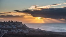 Sunset clouds over Sidi Ifni city in Morocco ocean coast landscape Time lapse travel Background
