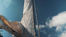 Main sail on a sailing boat being hoisted, raising the sail on a yacht, boating video