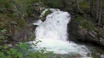 Waterfall in mountain stream in pure alps nature
