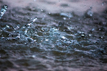 rain falling on choppy water 