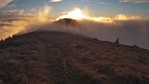 Magic sunny morning nature at sunrise with fast clouds motion over autumn mountain peak Time lapse
