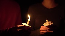 a person holding a candle at a candlelight service 