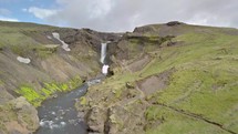 Aerial view of waterfalls in green volcanic nature in Iceland.

