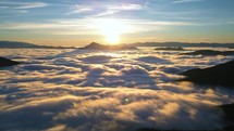 Time lapse of misty mountains nature in magic morning sunrise with foggy clouds motion fast in valley Aerial view
