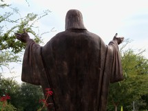 A statue of Jesus with His hands outstretched to teach, minister and encourage all who see Him. 