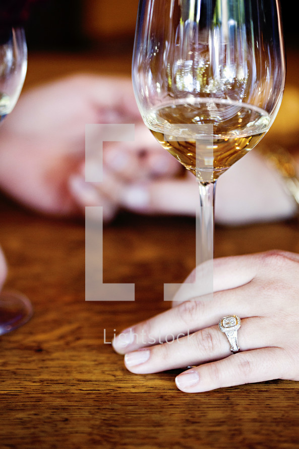 engagement ring and a wine glass