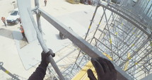 POV shot on a construction worker working on scaffold in a construction site.