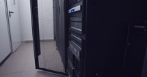 Large computer server room in a data center with blinking lights