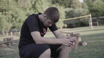 a young man praying outdoors 