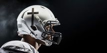 Team Jesus. Close-up of an american football player wearing a helmet with a cross
