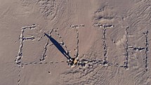 word faith drawn in sand 