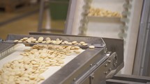 Biscuits moving fast in production belt line machine in automation food factory.
