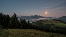 Moon set dawn and sunrise in foggy mountains landscape Time lapse
