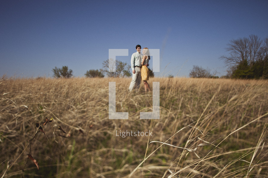 A couple embracing in a field
