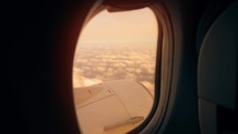 Sunset and Journey from the Airplane Window. Plane Flights Over Fluffy Clouds. Passenger window panorama view.