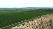 Car driving in field aerial view	