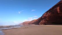Beautiful view of red cliff in ocean coast beach in Morocco nature landscape
