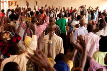 raised hands in an African church 