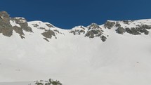 Panorama of Sunny winter mountains range in sunny day in snowy nature with blue sky
