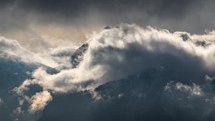 Time lapse of dramatic clouds motion fast in mystic winter alps mountains nature
