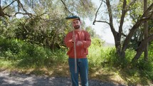 Young Man Cheerfully Twirls His Broom Outside In The Countryside In Calabria