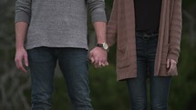 couple standing together holding hands 