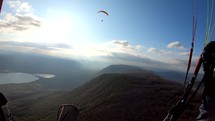 Adrenaline  paragliding flight over colorful autumn landscape.
