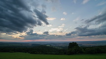 Panoramic time lapse of a colorful sunset sky over countryside 
