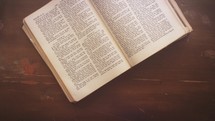 Open Bible lying on an antique desk
