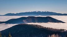 Winter alps mountains above foggy clouds in cold sunny morning landscape Time-lapse nature
