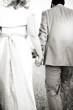 couple walking holding hands bride and groom wedding