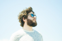 side profile of a man with a beard in sunglasses 