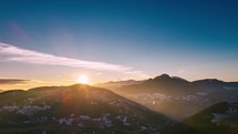 Aerial hyperlapse of sunrise above spring alpine mountains in Europe landscape, panorama
