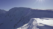 Panoramic view of snowy winter alps mountains in beautiful sunny day
