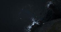 Seagulls Flying Over Black Sand Beach In Iceland, Aerial View At Night 