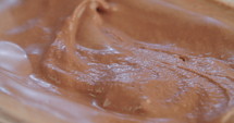 Macro slow motion of chocolate ice cream with scoop
