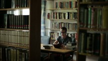 college student studying in a library 