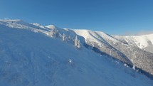 Panorama of Frozen alps mountains ski resort. Freeride powder day in cold winter morning with blue sky
