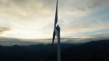 Wind turbine at cloudy sunset