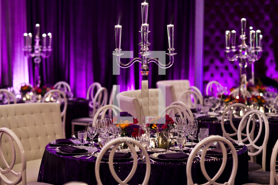 place setting at a set table formal dining, purple decor drapes, crystal centerpiece 