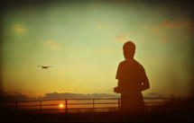 Boy flying remote-controlled airplane
