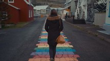 a woman walking on a colorful path 