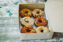 donuts with sprinkles in a box 